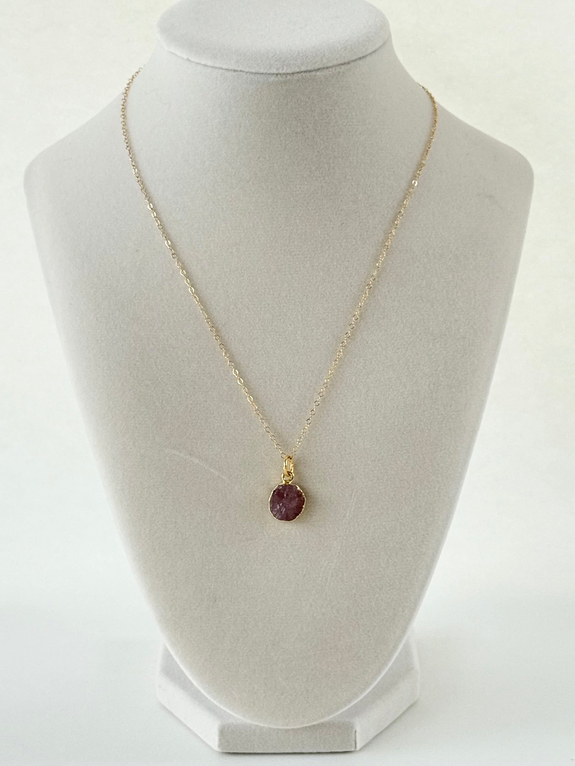 Handmade gold filled necklace with pink natural pendant on mannequin by studio hill designs.