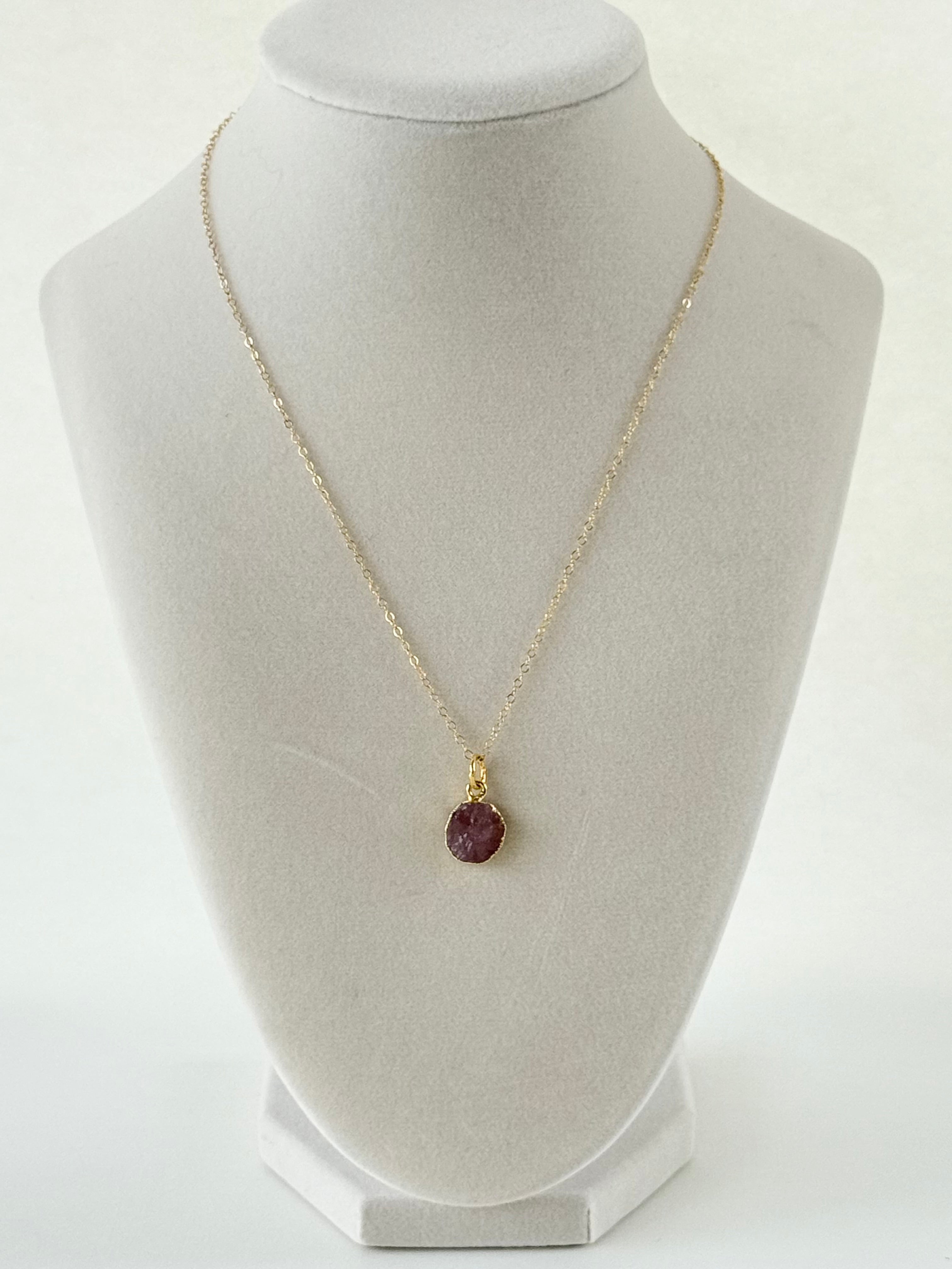 Handmade gold filled necklace with pink natural pendant on mannequin by studio hill designs.