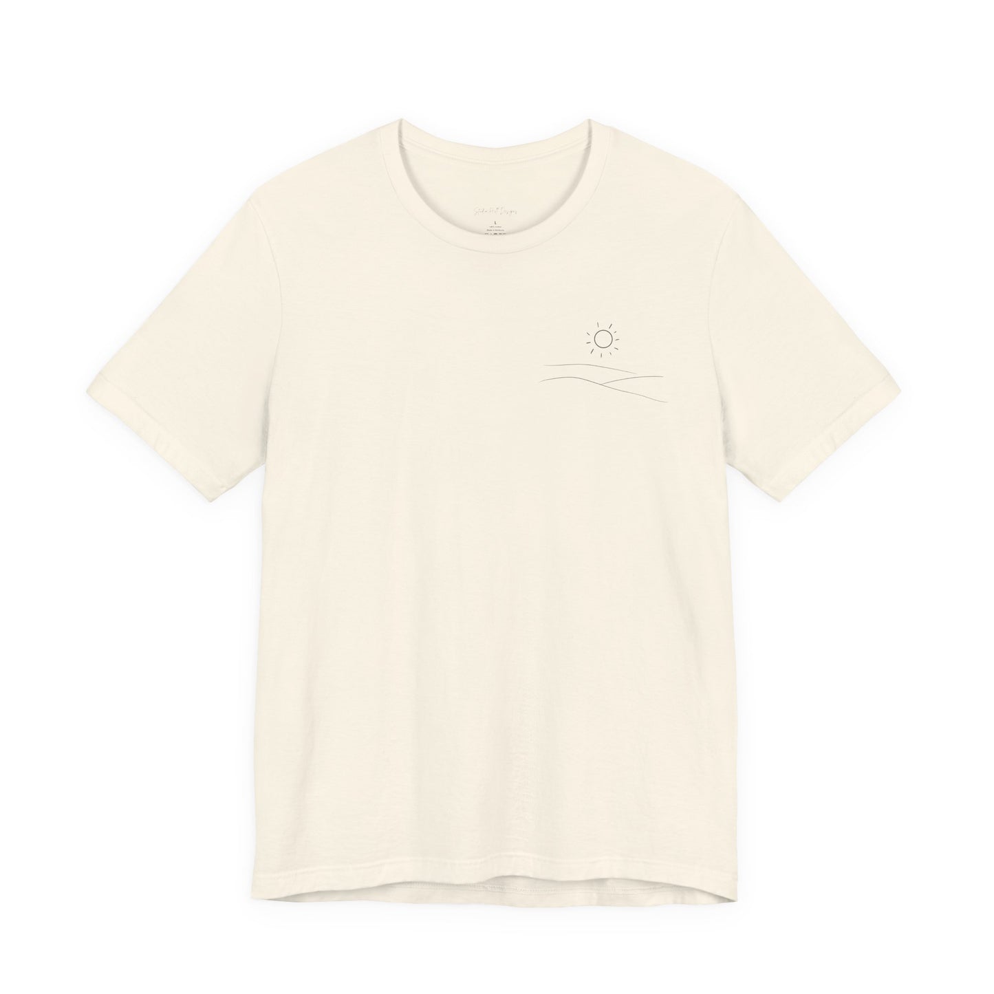 cream studio hill designs signature  t-shirt with a small rolling hills and sun logo on a white background