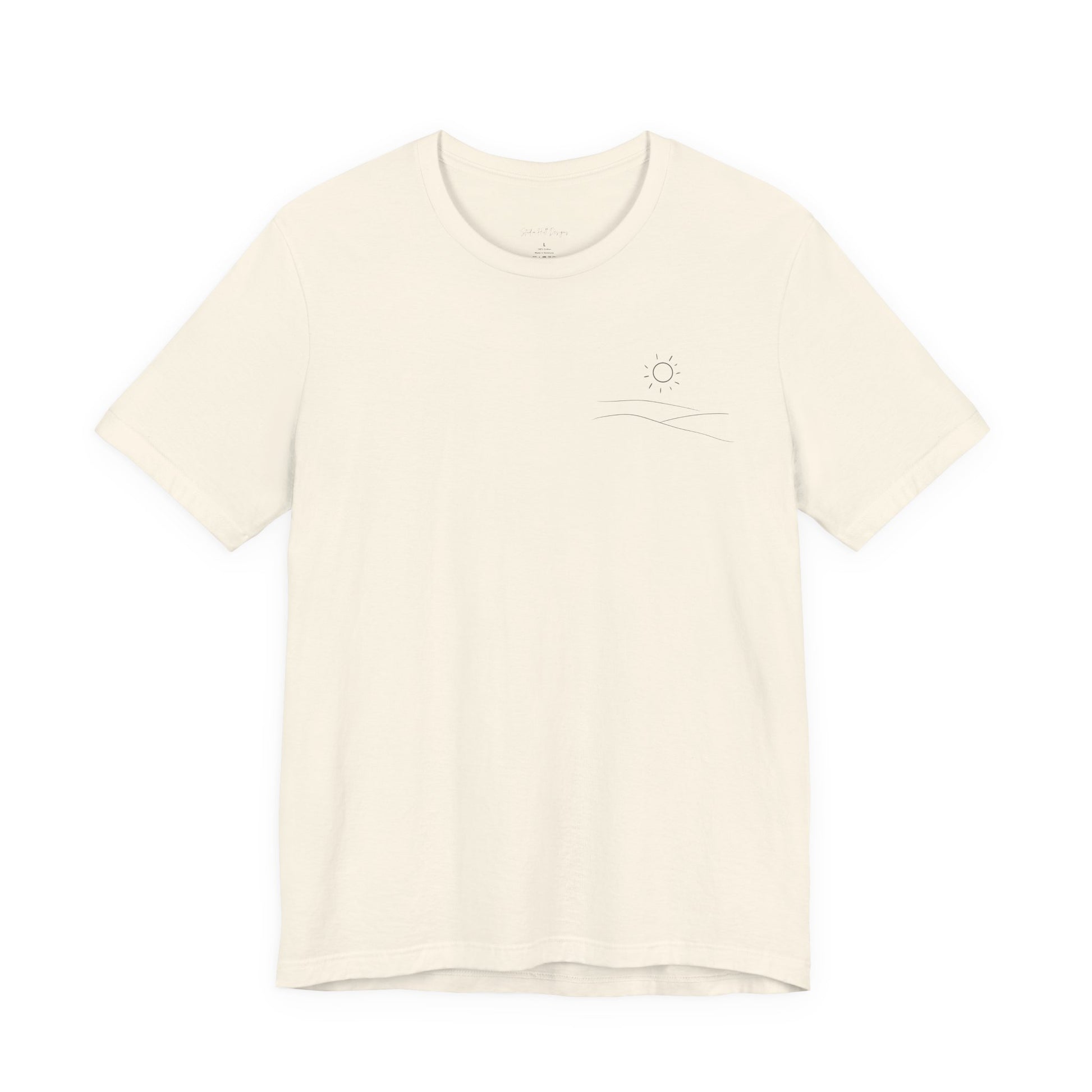 cream studio hill designs signature  t-shirt with a small rolling hills and sun logo on a white background