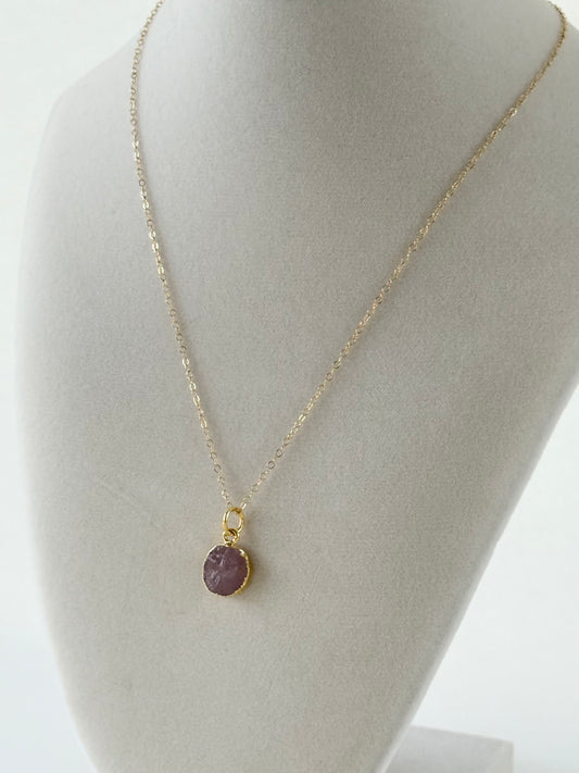 Handmade gold filled necklace with pink natural pendant on mannequin by studio hill designs.