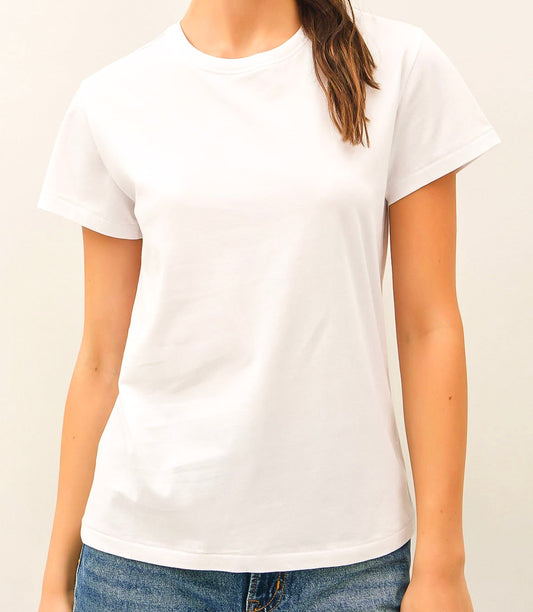 Person wearing a The Essential Cotton Tee by Studio Hill Designs in white with solid cream background.