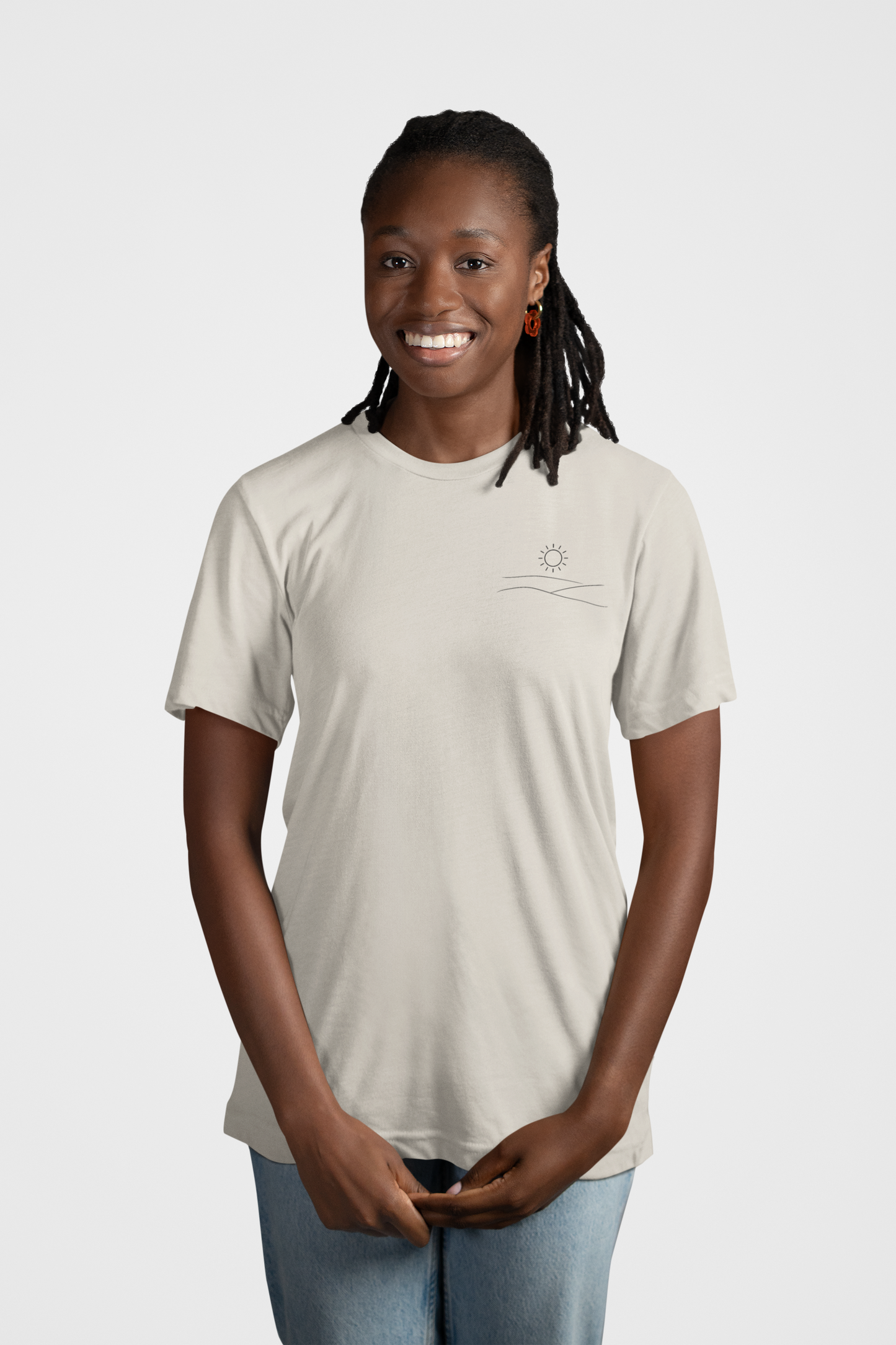 Mockup of woman smiling wearing grey studio hill designs signature tell with a neutral background.