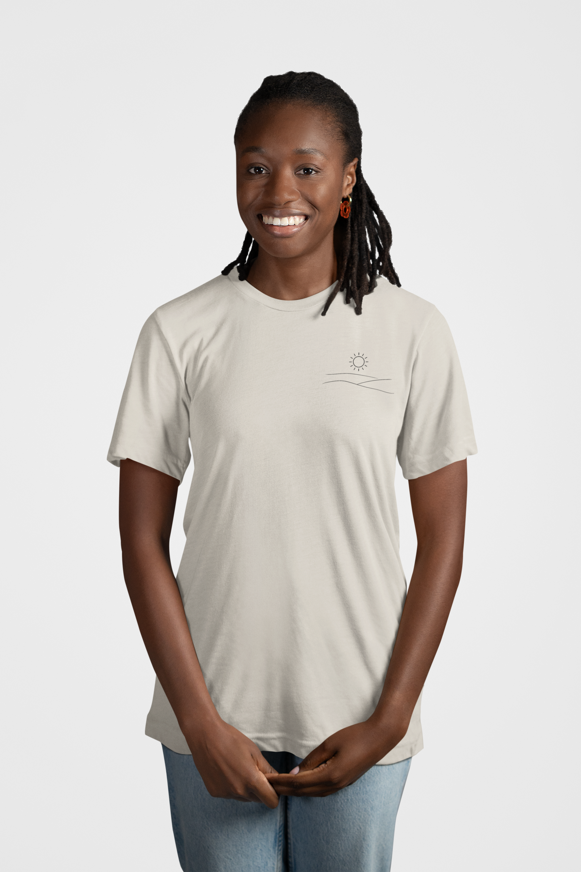 Mockup of woman smiling wearing grey studio hill designs signature tell with a neutral background.