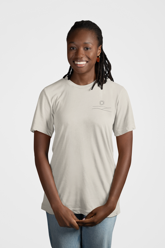 Mockup of woman smiling wearing grey studio hill designs signature tell with a neutral background.