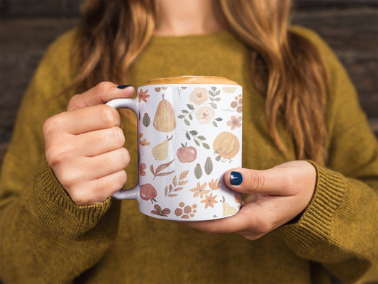 Person holding The Autumn Edit mug with autumn-themed design, designed by Stuidio Hill Designs